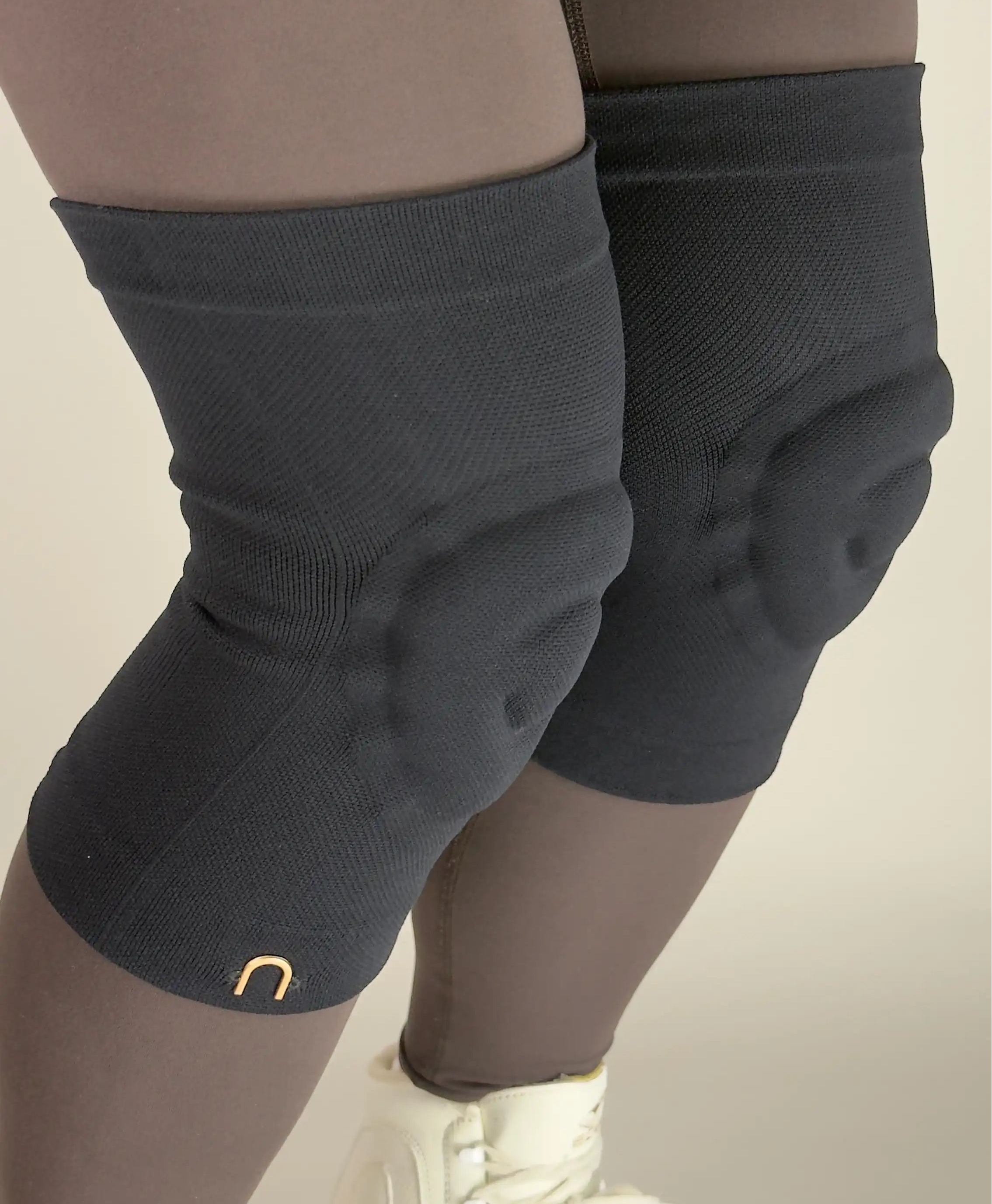 Black knee guards for figure skaters